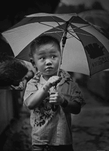 boy umbrella 216x300 Travel insurance tips for China
